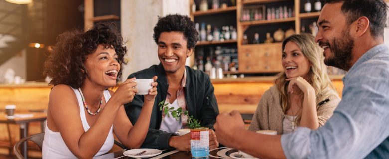 A group of friends enjoys time together at a coffee shop.