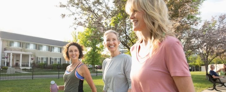 Three women out for a walk in the park.