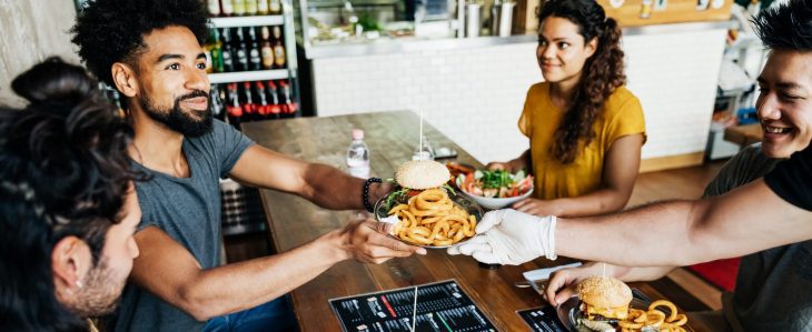 A group of friends have a meal together at a restaurant.