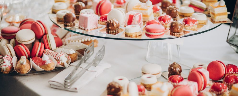 A selection of pink and white macaroons, canolis and other pastries.