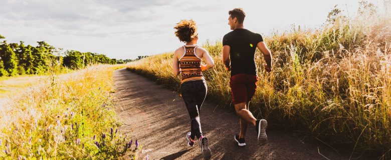 Two people jogging on a trail.