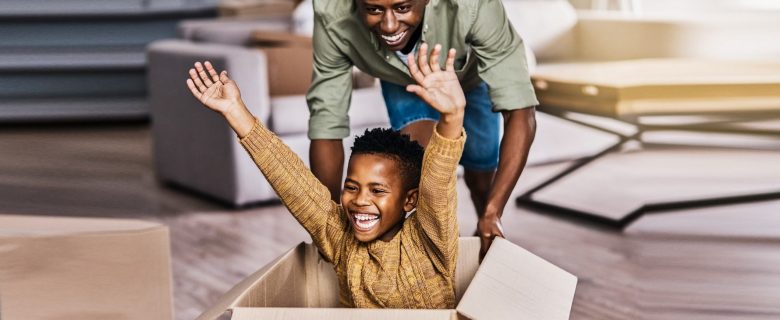 A man and his son playing in their living room.