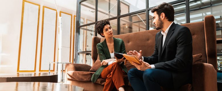 A woman interviews a man for a job.