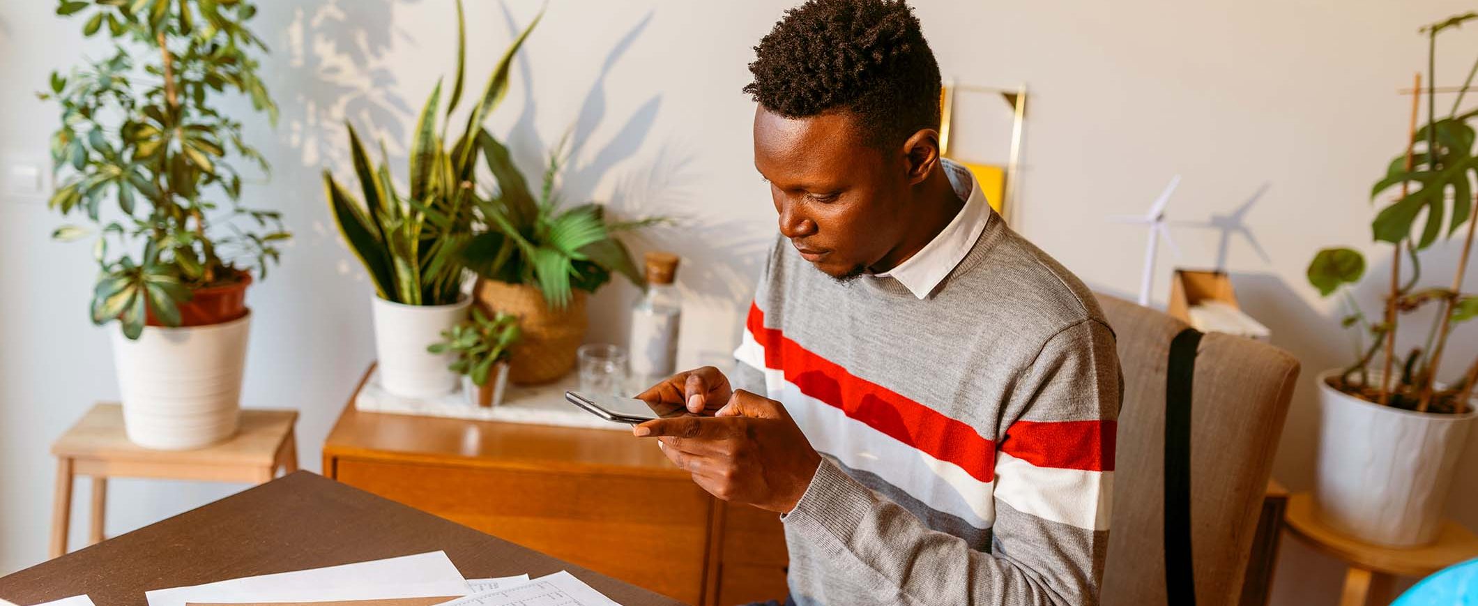 A man looks at his smart phone.