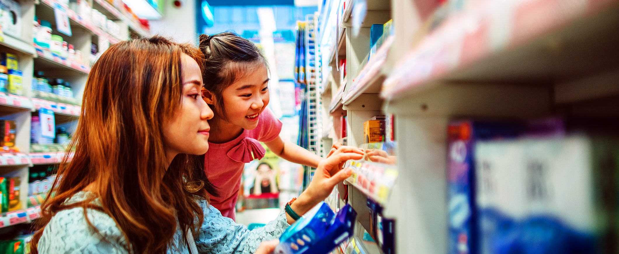 A mother and daughter shop in the grocery store.
