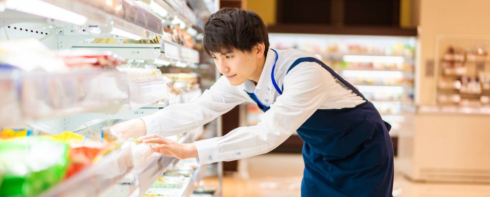 Man stocks shelves in a grocery store.