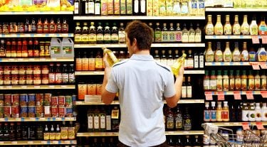 A man looks at groceries.