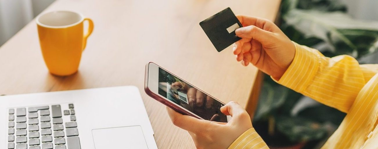 Close-up on someone entering card information into a mobile device.