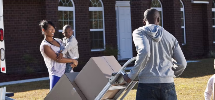 A wife and husband and their two young sons moving out of their house.