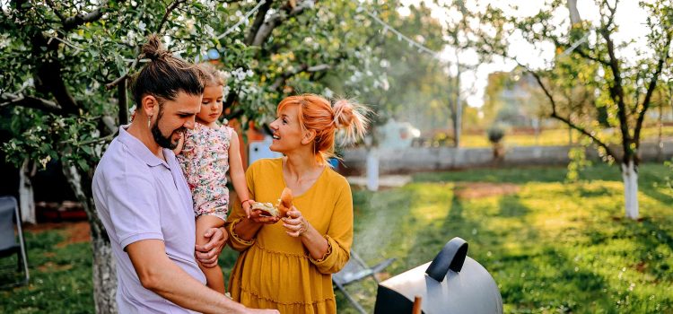A family are grilling in their backyard